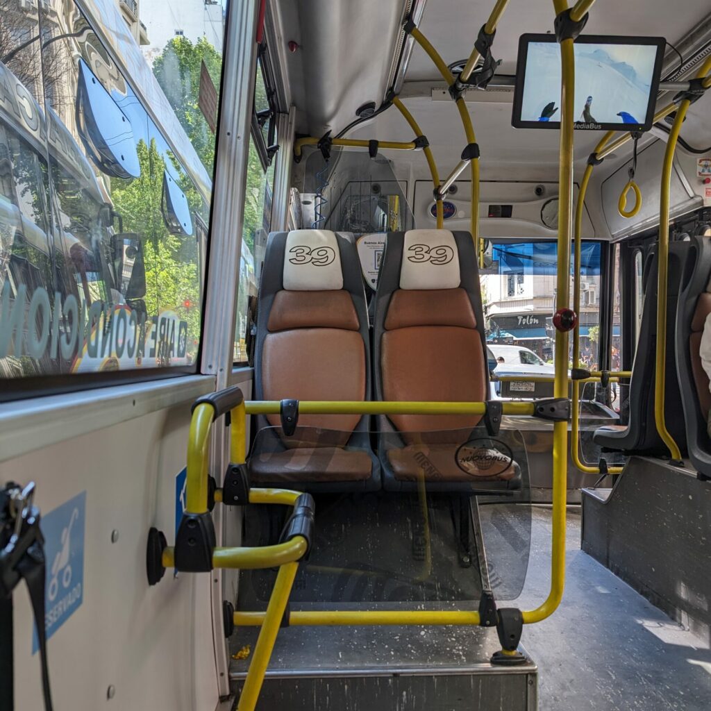 Interior of bus or colectivo with brown seats to navigate Buenos Aires