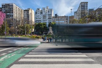 Buses and cars flying through an intersection in Buenos Aires, Argentina