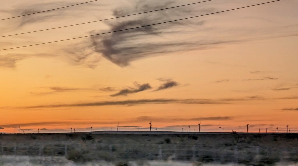 Sunset over the Argentine baren landscape with a wind farm.