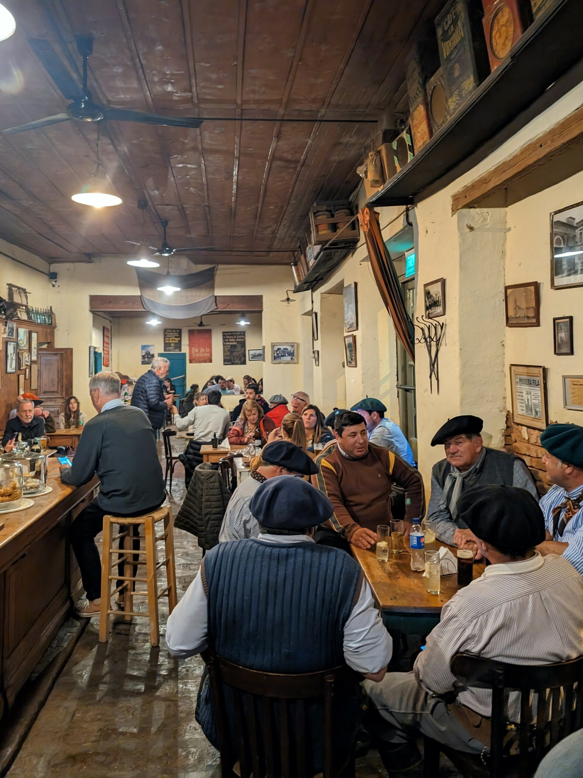 A bustling restaurant filled with people seated at tables, enjoying good company and delicious meals.