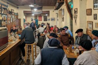 A bustling restaurant filled with people seated at tables, enjoying good company and delicious meals.