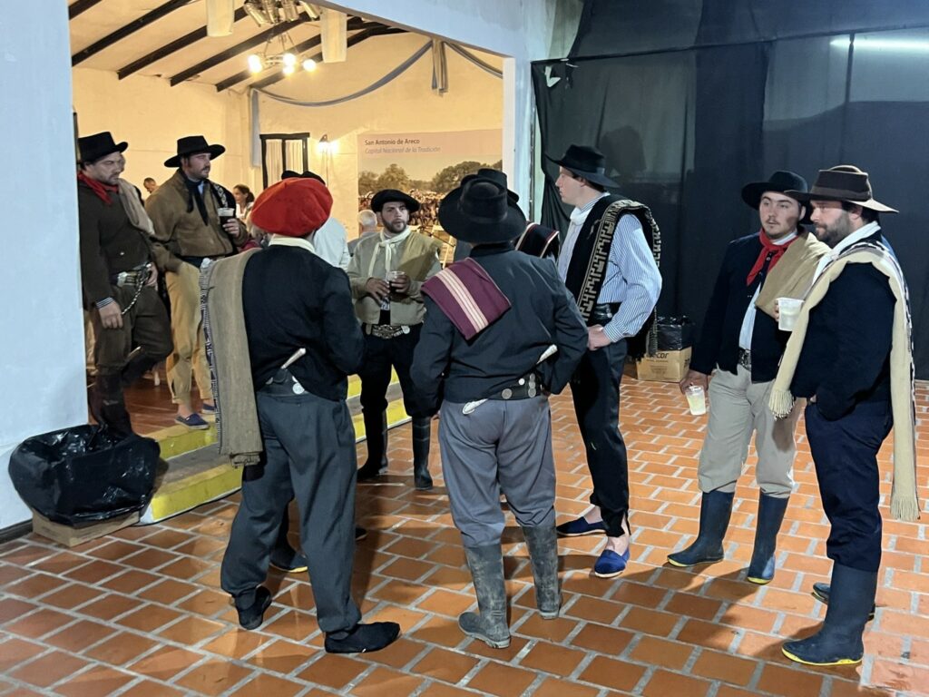 A group of men in period costumes standing around, adding a touch of history and charm to the scene.