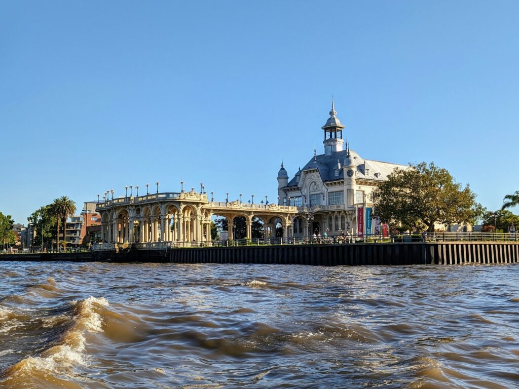 Building on the bank of a river with the sun shining