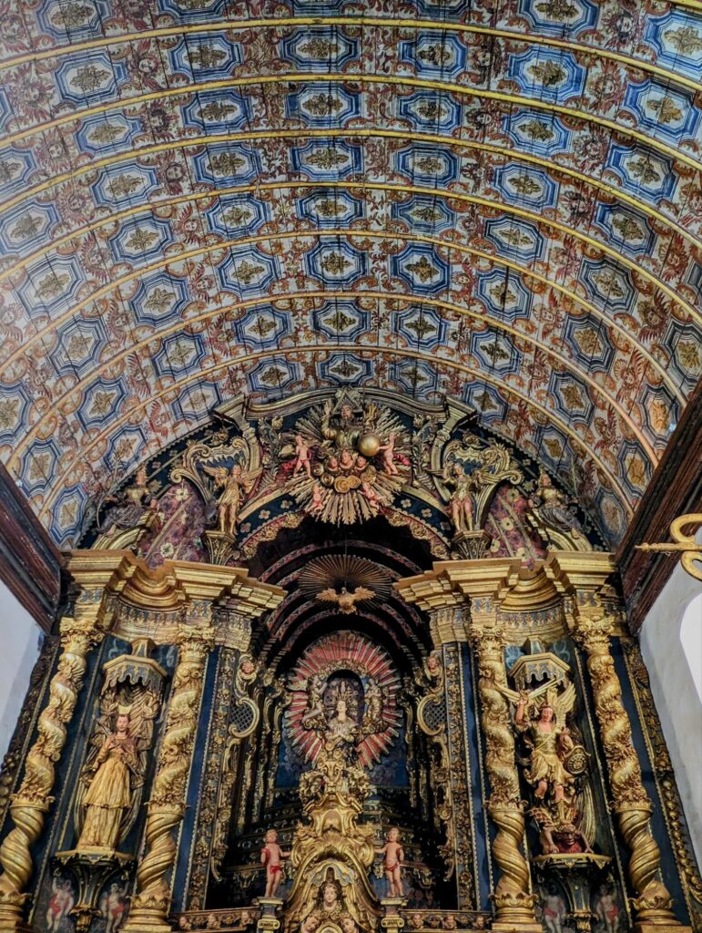Ornate gold altar with a wood painted ceiling