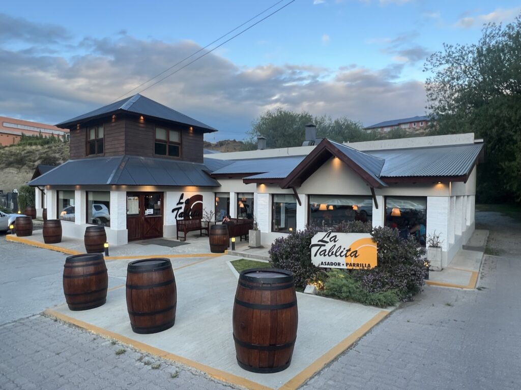 A restaurant with wooden barrels lining its sides, creating a rustic and charming ambiance.