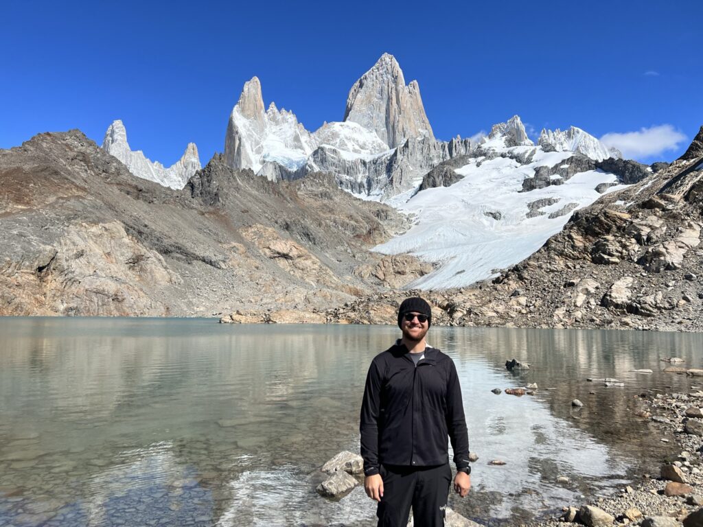 A man enjoying the serene beauty of a mountain lake.