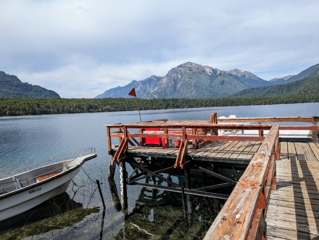 A dock on a lake with a mountain in the landscape
