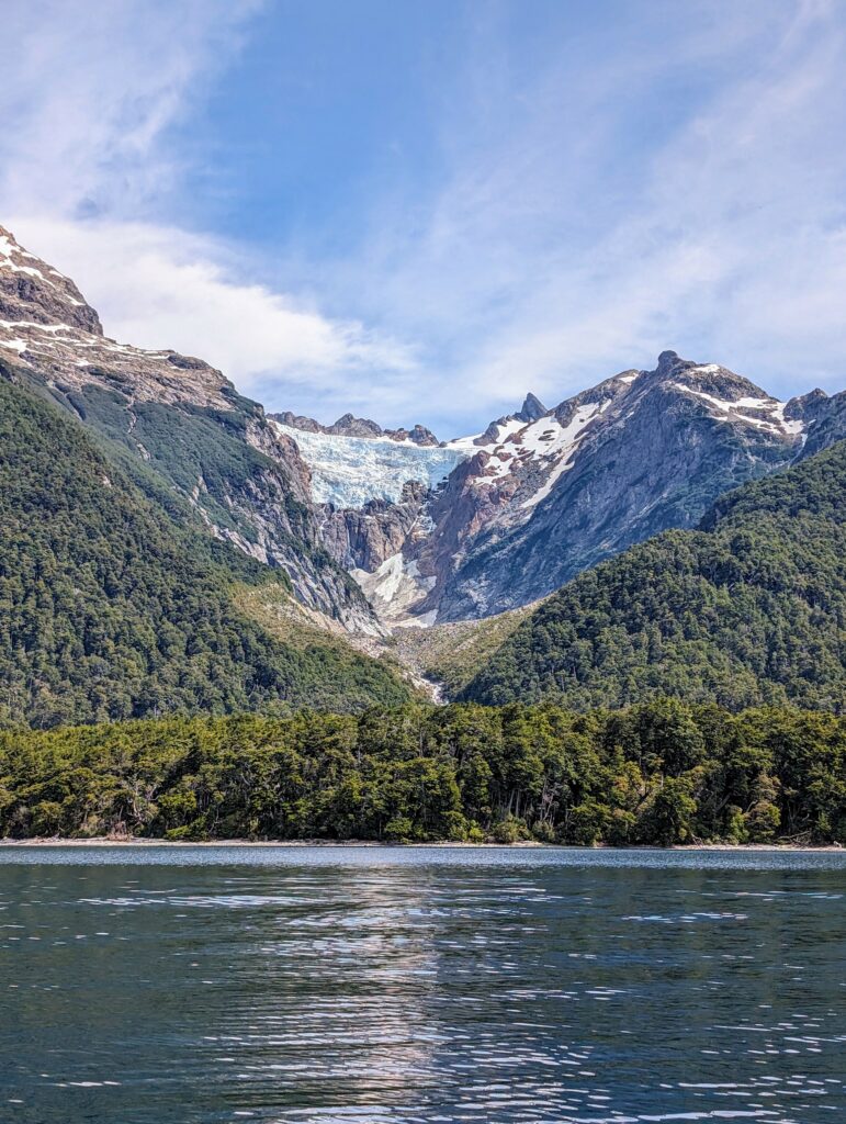 A glacier on a mountain above a lake