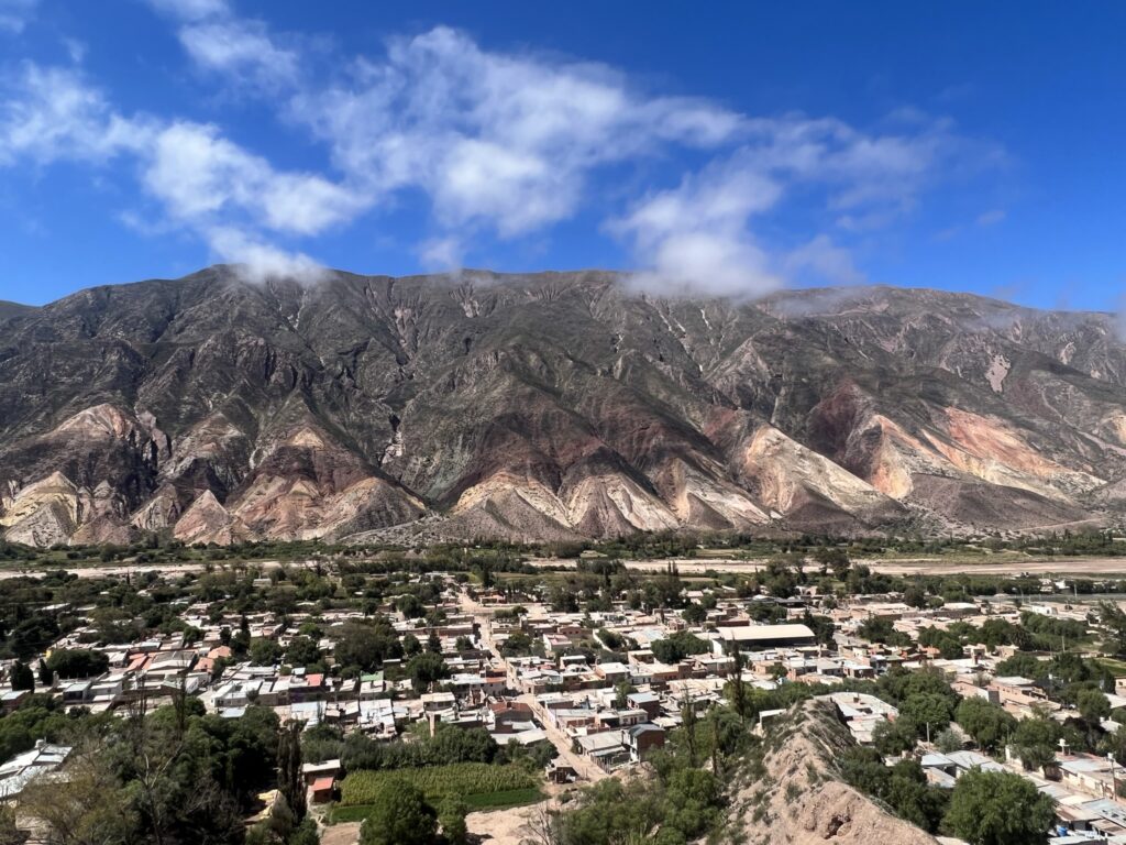 A town at the foot of a colorful mountain