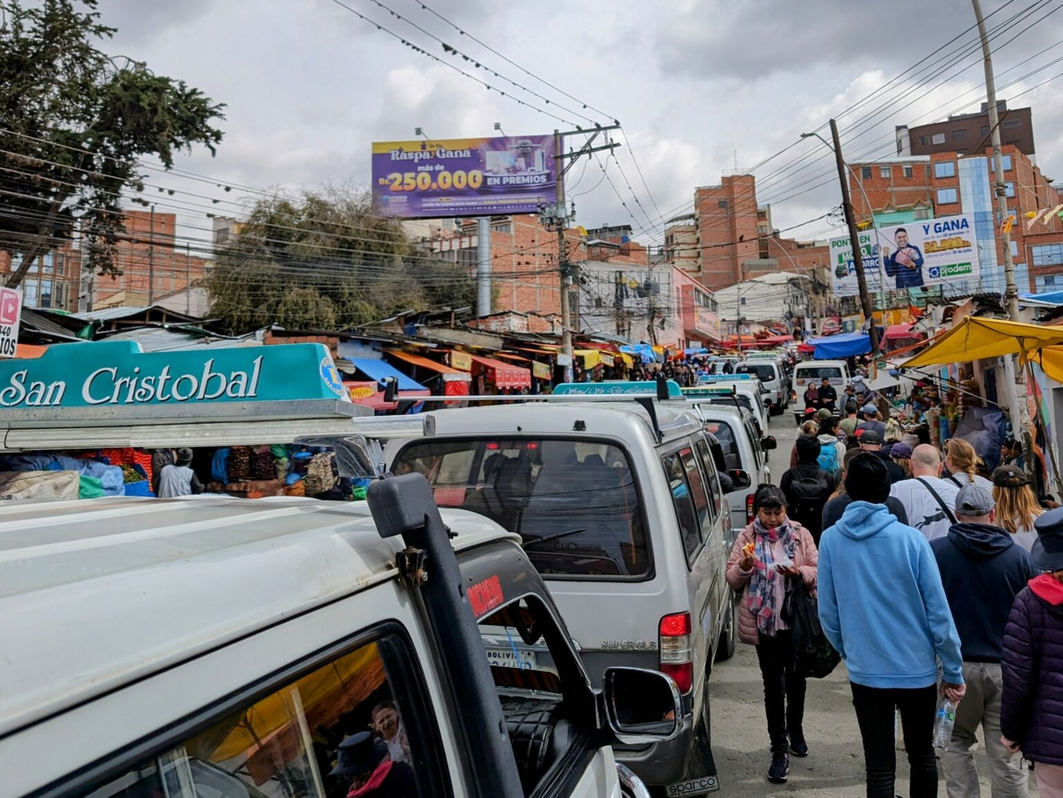 Buses and cars and people flowing through the city of La Paz, Bolivia