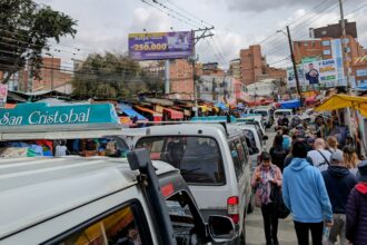 Buses and cars and people flowing through the city of La Paz, Bolivia