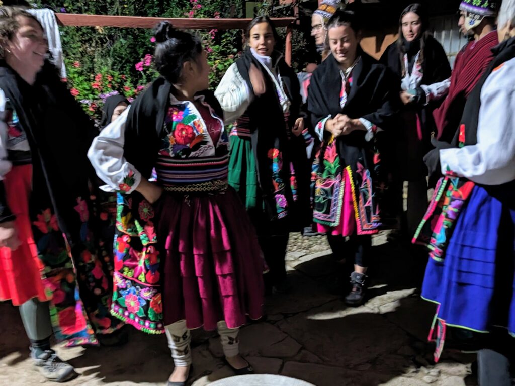 Women dancing and dressed in colorful skirts during a Lake Titicaca homestay