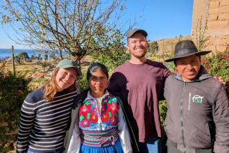 Four people smiling at the camera during a Lake Titicaca homestay