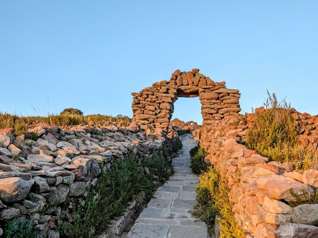 A path leading to an stone archway, visited during the Lake Titicaca homestay tour