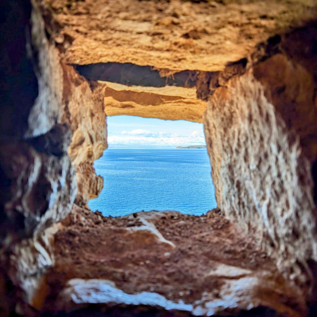The view of water from a stone window in Lake Titicaca