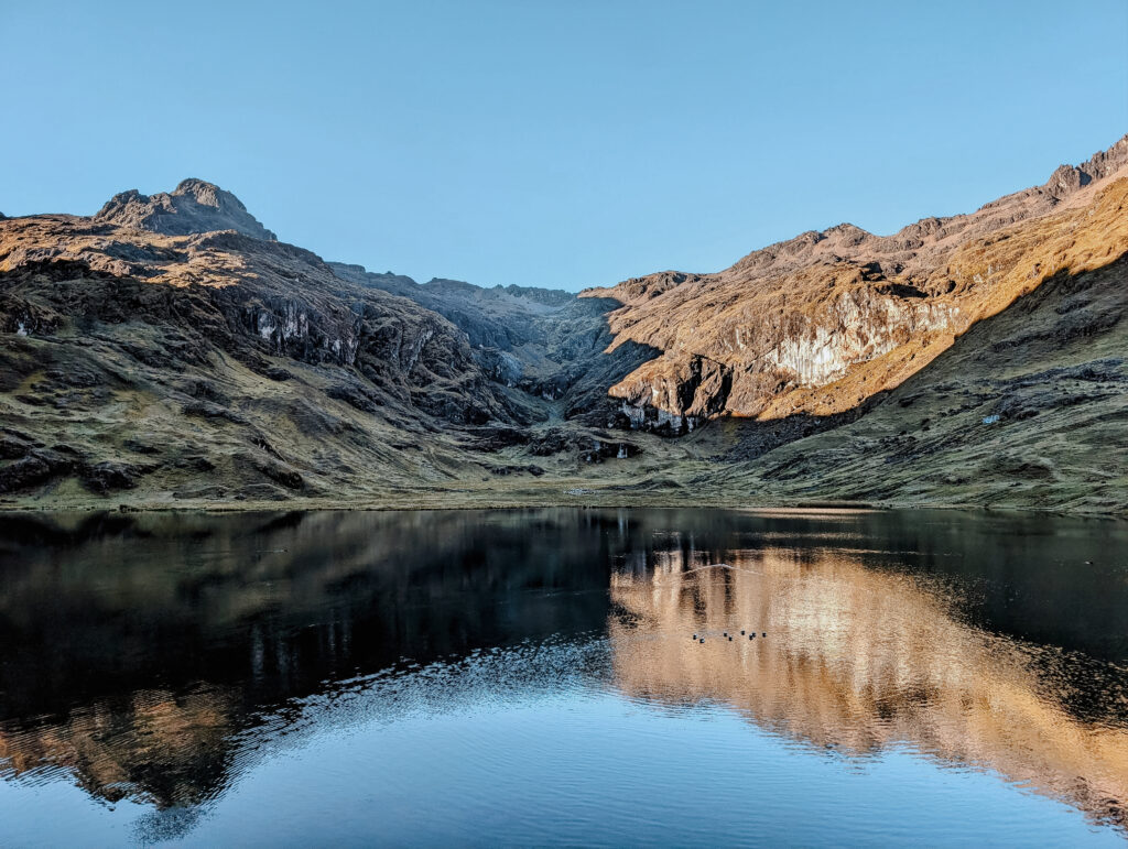 A lake with a mountain reflection in it on the Lares Trek