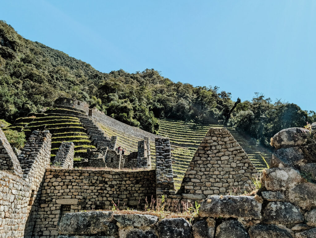 Stone ruins in front of a hill of farming terraces on the Short Inca Trail