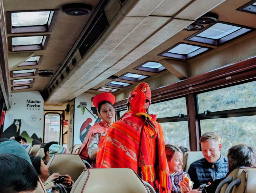 Two people in traditional Inca dress on the train to the Short Inca Trail