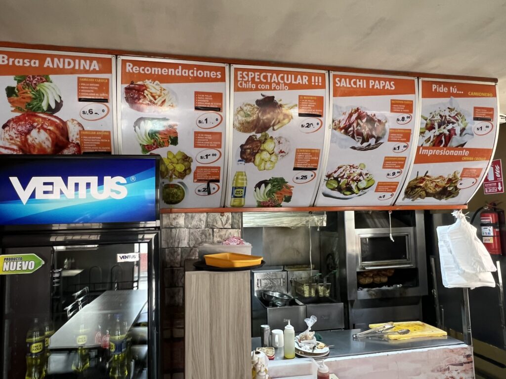 A restaurant menu on the wall of a restaurant in Arequipa