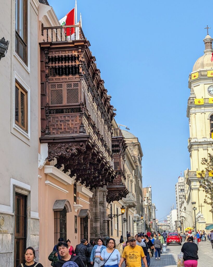 A wooden enclosed balcony protruding over the street in the historical center of Lima