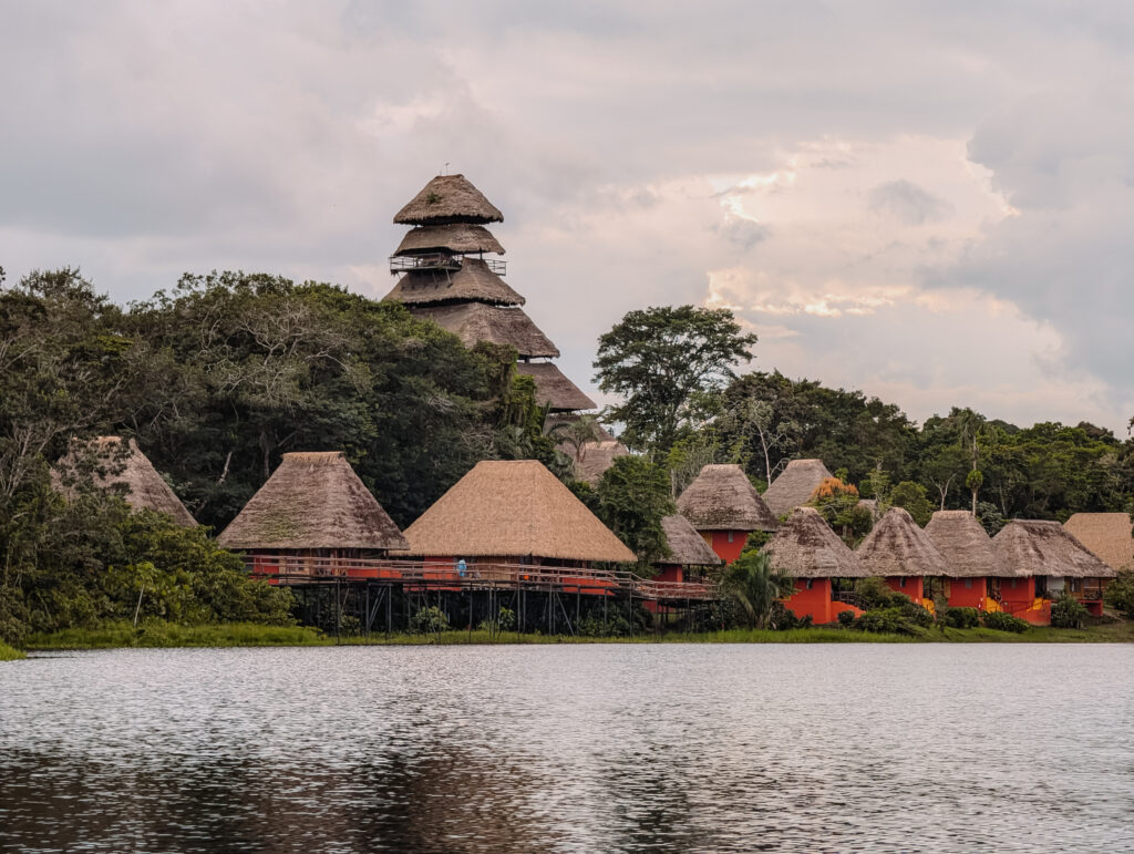 A collection of cabins along a lake within the Amazon Rainforest