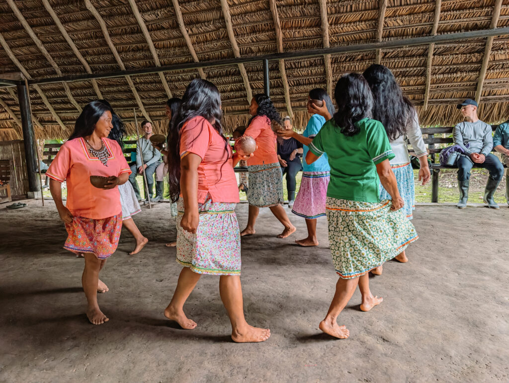 Women of an indigenous community in a circle when visiting the Napo Wildlife Center