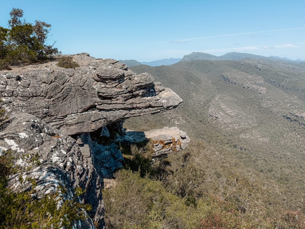 The view from and overlook onto a rock and a valley in Grampians