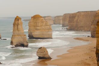 rock formations in an ocean along a cliff of the Great Ocean Road